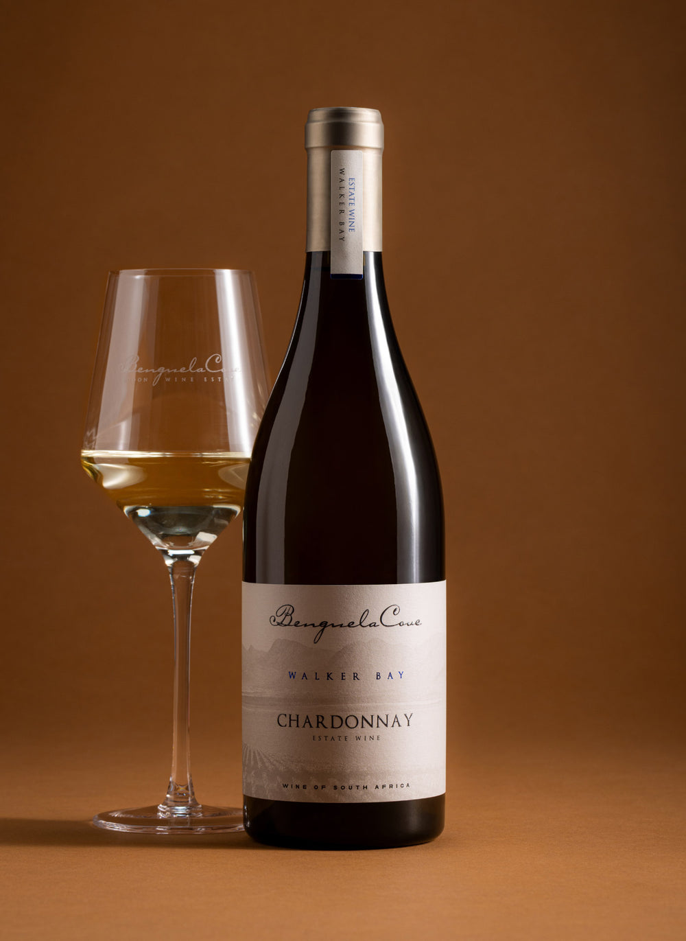 Bottle of Chardonnay wine with fruits and cheese on a blue background