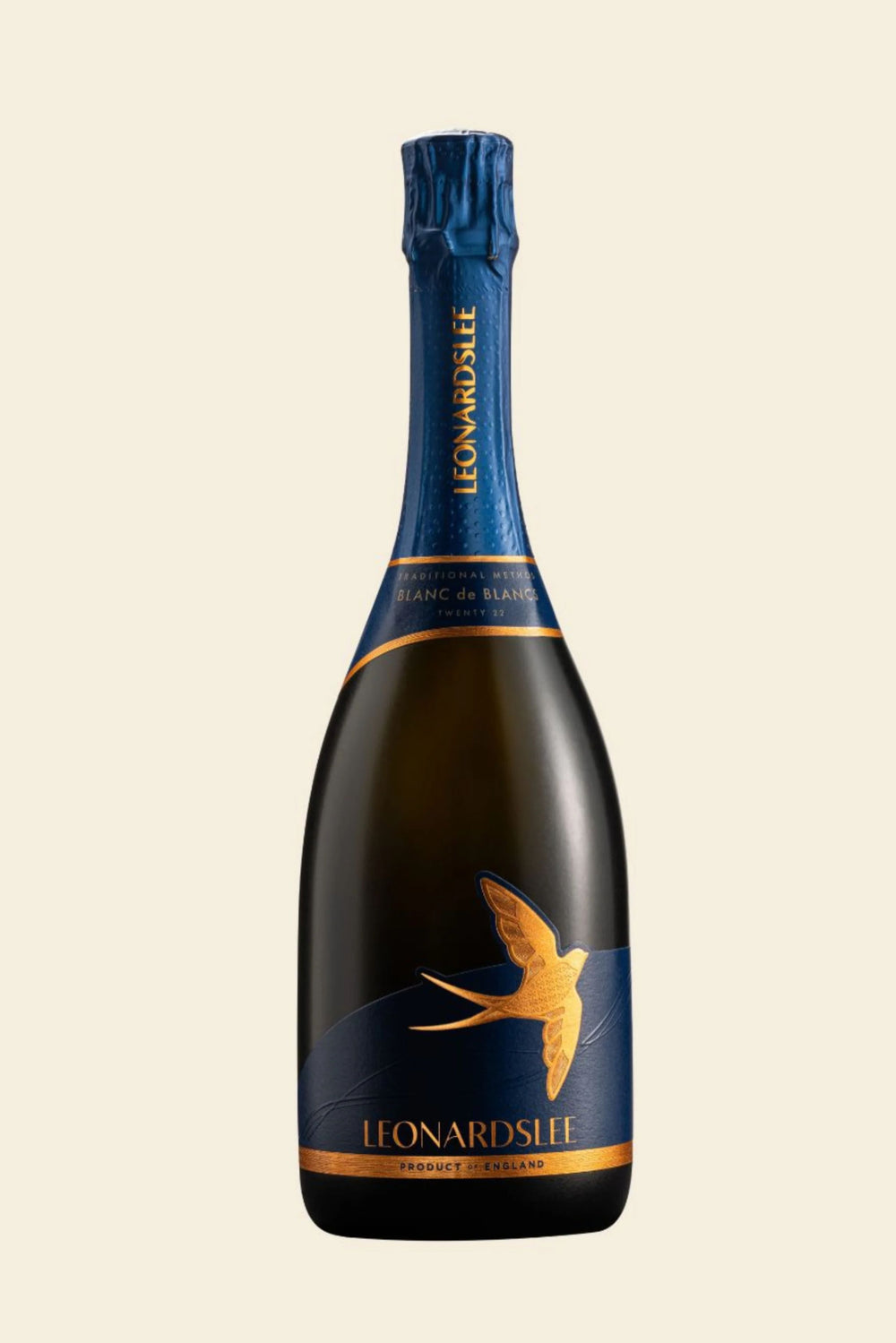 A bottle of Leonard Sife Brut de Blancs Champagne with a dark glass body, a deep blue foil and label, and a gold swallow graphic, set against a solid light beige background.