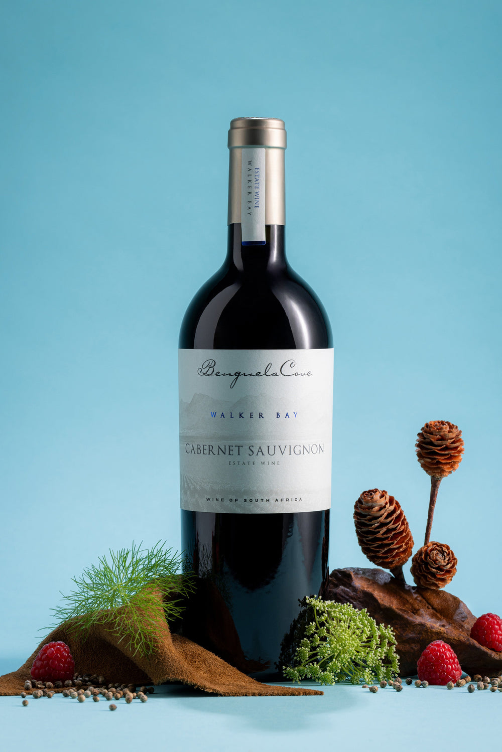 Bottle of Cabernet Sauvignon wine with decorative elements on a blue background